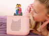 Child listening to Scarecrows' Wedding on pink Toniebox